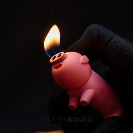 A pink pig shaped lighter with a whimsical pig-shaped design on its surface